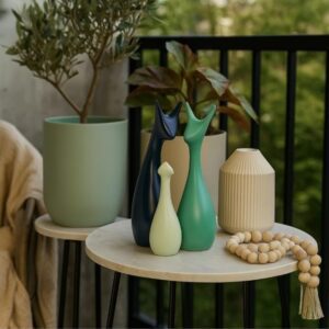 Set of 3 minimalist cat figurines placed on a modern table with plants for home decor